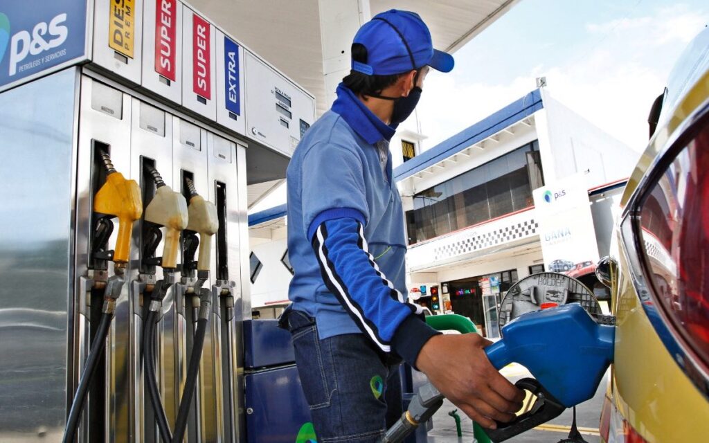 Trabajador de una estación de servicio abastece de combustible a un vehículo.