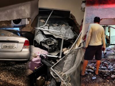 Un automóvil entre escombros y estructuras dañadas en el interior de una vivienda.